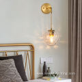 Copper wall lamp with suspended grain glass ball